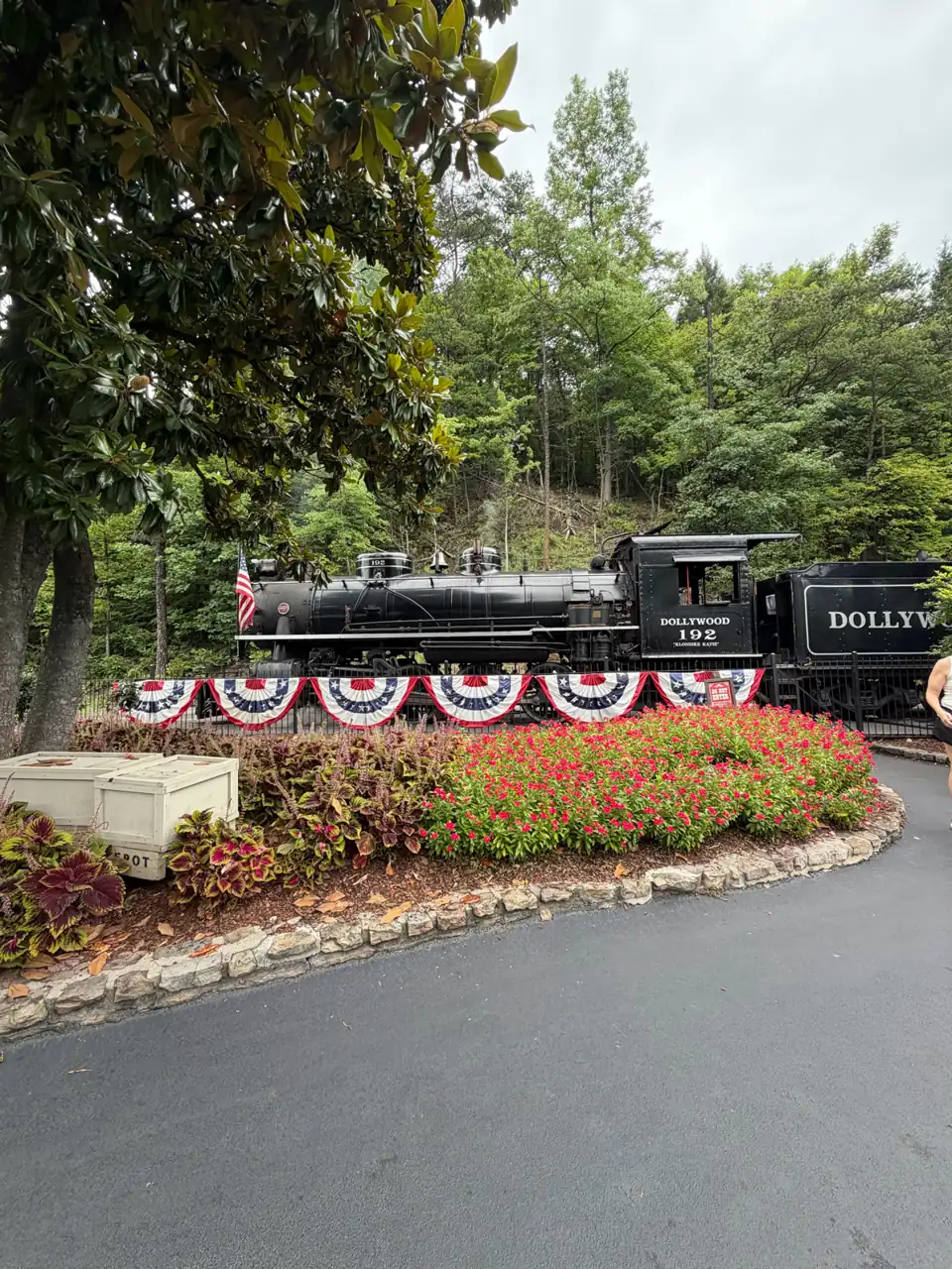 Vintage steam locomotive parked behind a flower bed at Dollywood