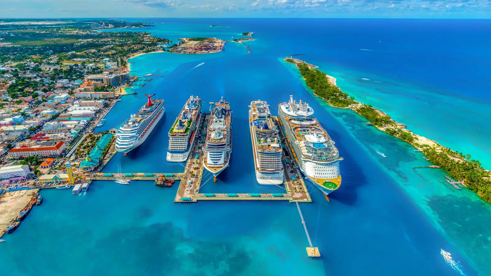 Aerial view of cruise ships docked in bright turquoise Caribbean water