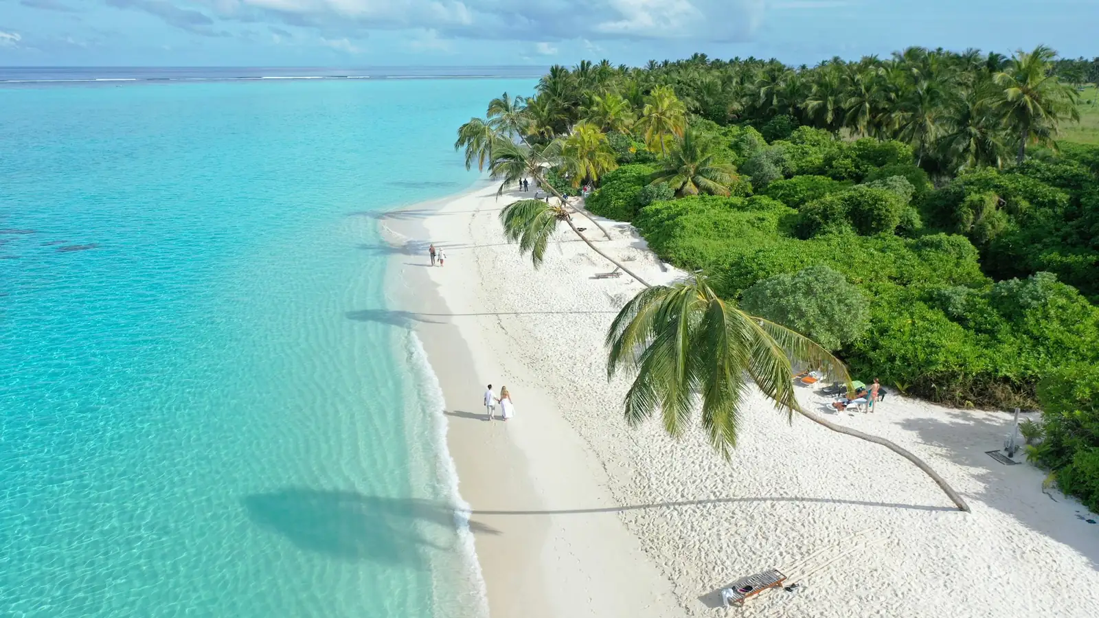 Aerial view of a white-sand tropical beach with turquoise water