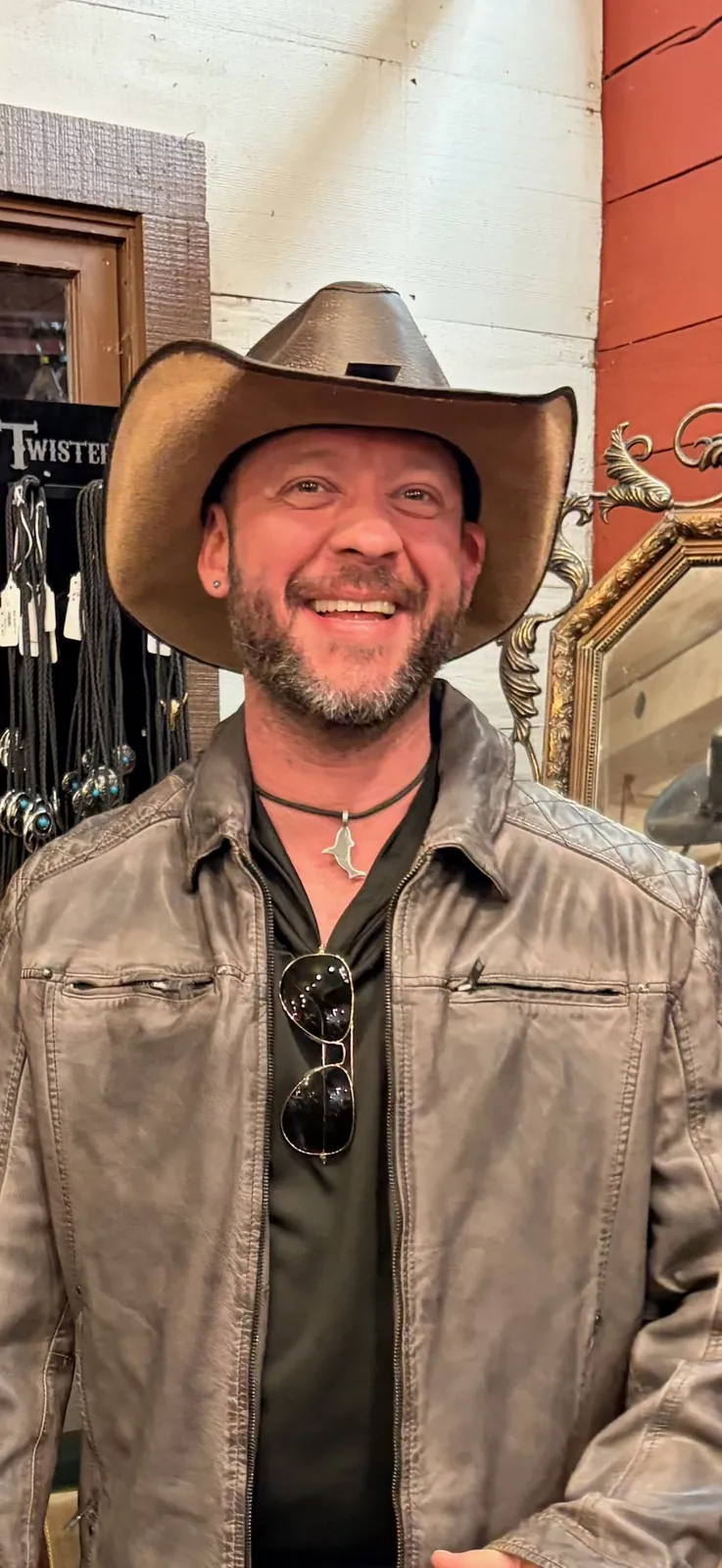 Fox, your travel advisor, smiling in a cowboy hat and leather jacket